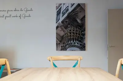 a table with two chairs and a picture on the wall at MH Apartments Ramblas in Barcelona