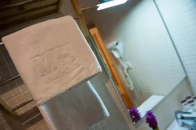 a towel hanging on the side of a shower at MH Apartments Ramblas in Barcelona