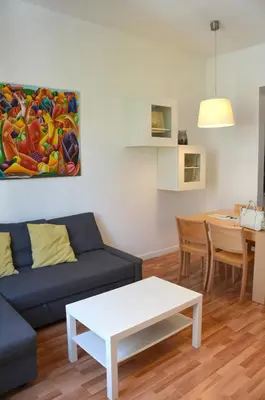 a living room with a couch and a table at Claris Apartments in Barcelona