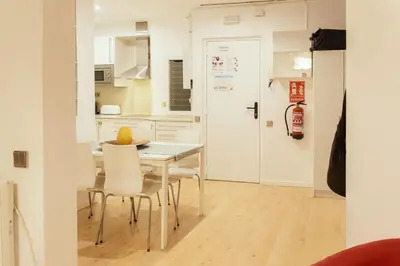 a kitchen and dining room with a table and chairs at Nice apartment in the middle of Born in Barcelona