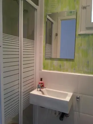 a bathroom with a white sink and a mirror at Fira Plaza España Apartment 3ʳᵈ Floor Balcony in Barcelona