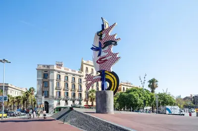 a statue in the middle of a street with a building at Citytrip Barceloneta Beach in Barcelona