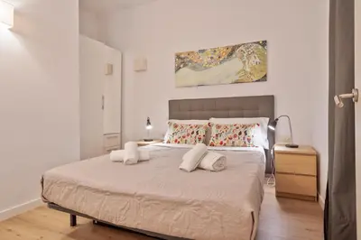 a bedroom with a bed with two towels on it at Citytrip Barceloneta Beach in Barcelona