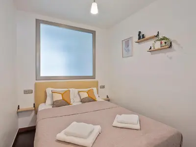a bedroom with a bed with two towels on it at Citytrip Poble Nou Beach in Barcelona