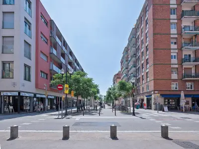 an empty street in a city with tall buildings at Citytrip Poble Nou Beach in Barcelona