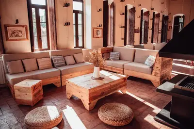 a living room with couches and a table and a piano at El Molí Blanc in Lavid