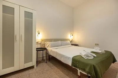 a bedroom with a large bed with two towels on it at bp1- Piso para Grandes Grupos in Barcelona