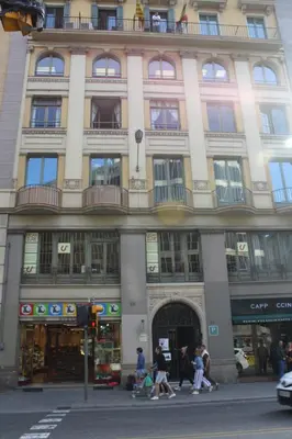 a large building with people walking in front of it at Pensión Casa Blanca in Barcelona