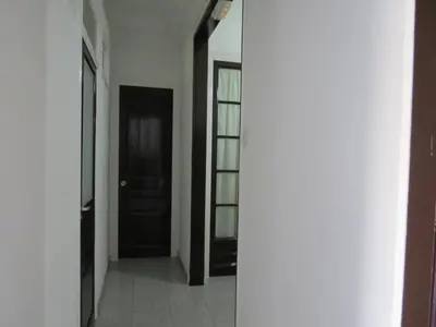 a hallway with a black door and a window at Pensión Casa Blanca in Barcelona