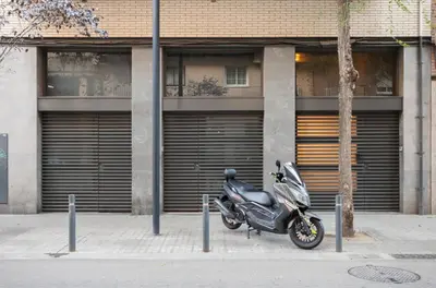 a motorcycle parked in front of a building at ApartsNouBcn Fira Barcelona in Hospitalet de Llobregat