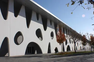 a building with circular windows on the side of it at ApartsNouBcn Fira Barcelona in Hospitalet de Llobregat