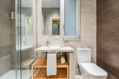 a bathroom with a shower toilet and a sink at Fuster Apartments by Aspasios in Barcelona