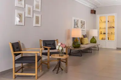 a living room with a table and chairs and a couch at RVHotels Broquetas Spa Termal in Caldes de Montbui