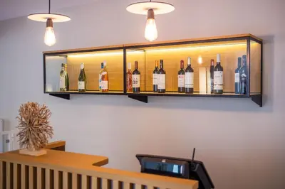 a shelf with bottles of wine on a wall at RVHotels Broquetas Spa Termal in Caldes de Montbui
