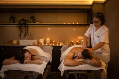a woman standing next to two men in beds at RVHotels Broquetas Spa Termal in Caldes de Montbui