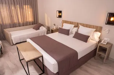 a hotel room with a large bed and a couch at RVHotels Broquetas Spa Termal in Caldes de Montbui