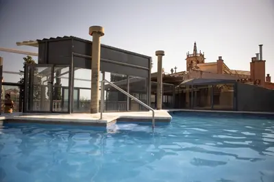 a swimming pool in front of a building at RVHotels Spa Vila de Caldes - Adults only in Caldes de Montbui