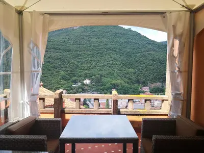 a room with a table and a view of a mountain at Casa les Pomeretes in El Figaró