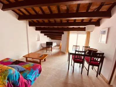 a living room with a couch and a table at Apartamentos Mitus in Canet de Mar