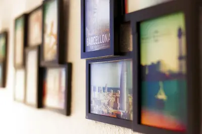a row of framed pictures hanging on a wall at Casa Tortilla Sagrada Familia in Barcelona