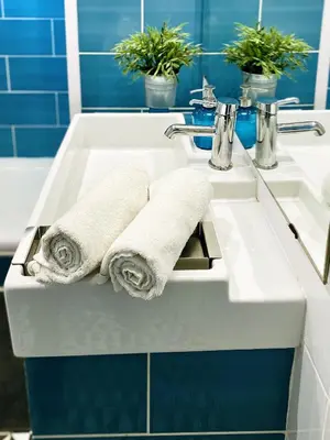 a bathroom sink with two rolled towels on it at Casa Tortilla Sagrada Familia in Barcelona