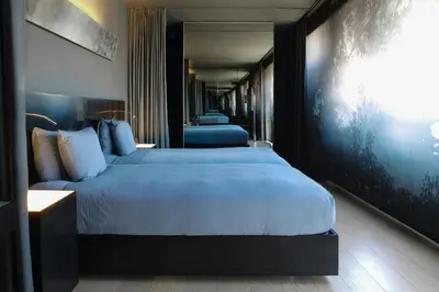a bedroom with two beds and a painting on the wall at Renaissance Barcelona Fira Hotel in Hospitalet de Llobregat