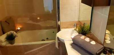 a bathroom with a tub and a sink and a bath tub at Ashram Villa Sunshine in Sitges