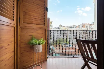 a balcony with a potted plant and a window at Beautiful & Luxury Apartment centrally-located in Barcelona