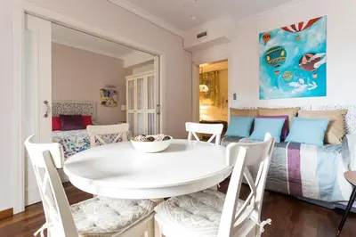 a white dining room with a white table and chairs at Beautiful & Luxury Apartment centrally-located in Barcelona
