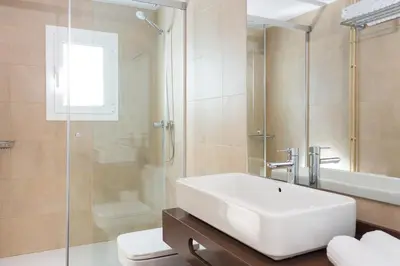 a bathroom with a sink and a shower and a toilet at Quartprimera Apartments in Barcelona