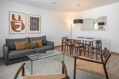 a living room with a couch and a table at The Corner Apartments by Aspasios in Barcelona
