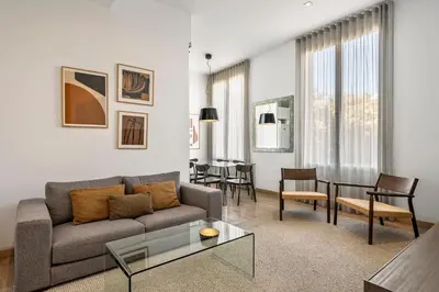 a living room with a couch and a table at The Corner Apartments by Aspasios in Barcelona