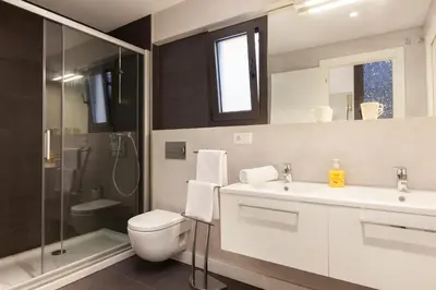 a bathroom with a toilet and a sink and a shower at Akira Flats Urgell apartment in Barcelona