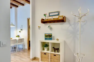 a living room with a shelf and a table at Charming & Convenient Apartment Near Plaza Espanya in Barcelona