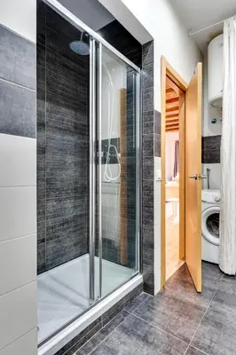 a glass shower in a bathroom with a toilet at Charming & Convenient Apartment Near Plaza Espanya in Barcelona