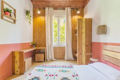 a bedroom with a bed and a window at Bird House in Barcelona