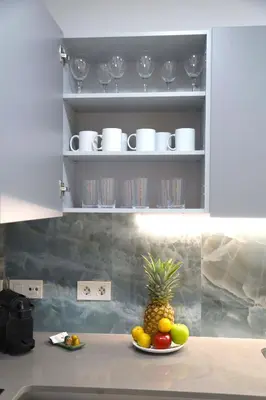a pineapple on a plate on a counter in a kitchen at Cosmo Apartments Consell de Cent - Plaza Universitat in Barcelona
