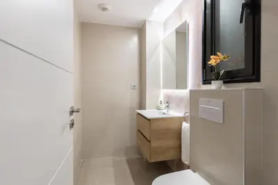 a bathroom with a white toilet and a sink at Cosmo Apartments Consell de Cent - Plaza Universitat in Barcelona