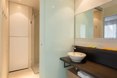 a bathroom with a sink and a mirror at Cosmo Apartments Passeig de Gràcia in Barcelona