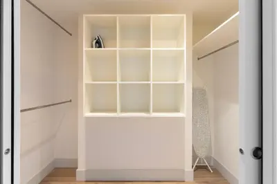 a walk in closet with white walls and shelves at Cosmo Apartments Passeig de Gràcia in Barcelona