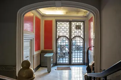 an archway leading to a hallway with a door at SibsBcn COLISEUM - Cozy and Central in Barcelona