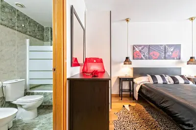 a bedroom with a bed and a toilet and a sink at Cálido apartamento con piscina en Barcelona in Ripollet