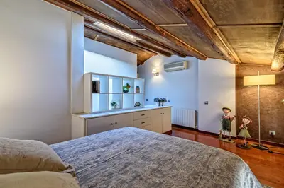 a bedroom with a large bed in a room at Apartamento con encanto en Badalona in Badalona