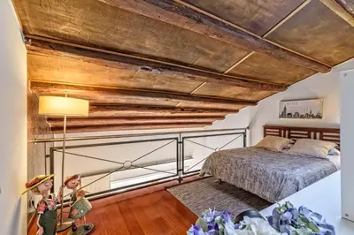a bedroom with a bed and a wooden ceiling at Apartamento con encanto en Badalona in Badalona