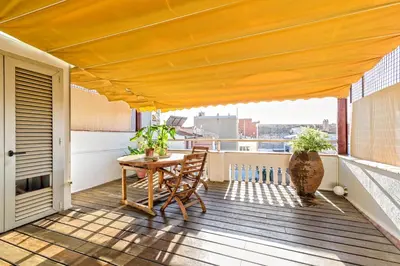 a patio with a table and chairs on a balcony at Apartamento con encanto en Badalona in Badalona