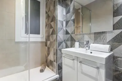 a white bathroom with a sink and a shower at Art House Cathedral Sagrada Familia in Barcelona