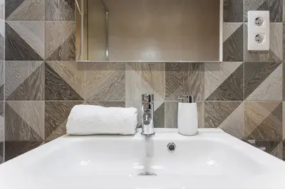 a white sink in a bathroom with a mirror at Art House Cathedral Sagrada Familia in Barcelona