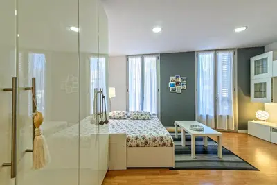 a bedroom with a bed and a glass shower at Loft en Badalona Centro in Badalona