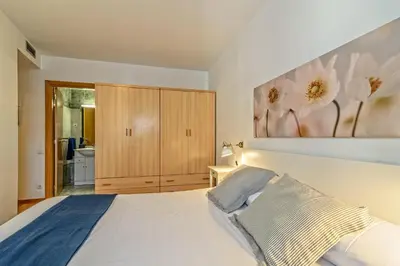 a bedroom with a bed and a painting on the wall at Apartamento&piscina cerca de Barcelona in Ripollet