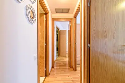 a hallway of a house with wooden floors at Apartamento&piscina cerca de Barcelona in Ripollet